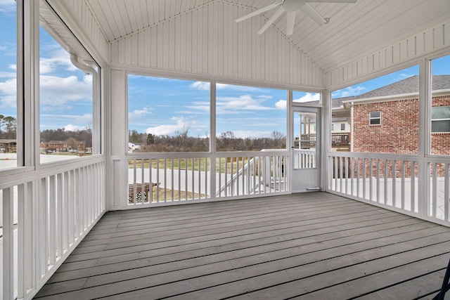 unfurnished sunroom with vaulted ceiling and ceiling fan