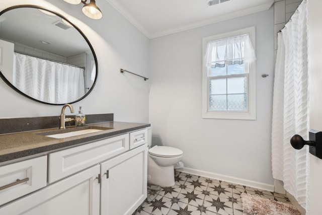 bathroom with vanity, crown molding, and toilet