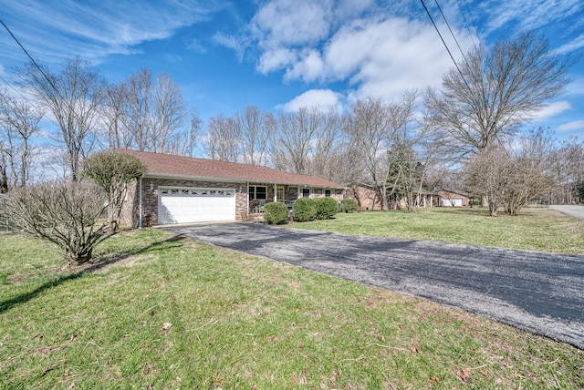 single story home featuring a garage and a front yard