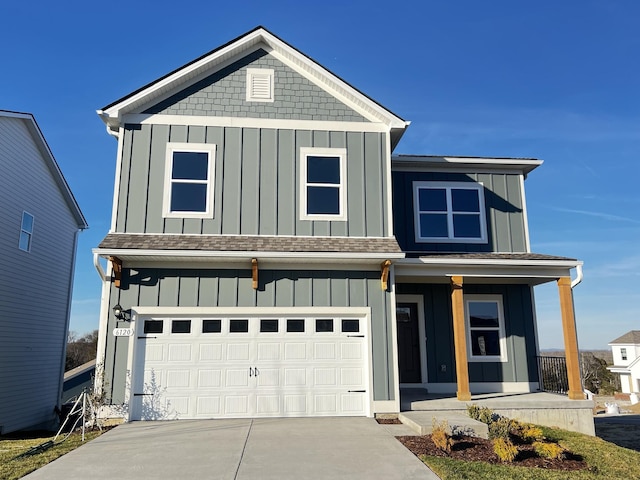 view of front of property with an attached garage, covered porch, board and batten siding, and concrete driveway