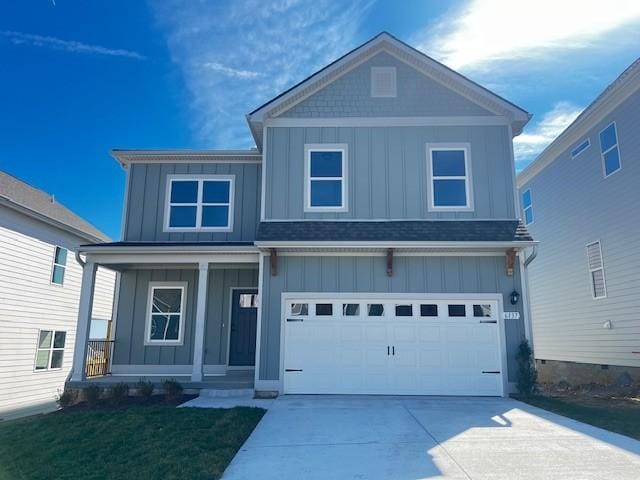 craftsman inspired home with a porch, a garage, concrete driveway, board and batten siding, and a front yard