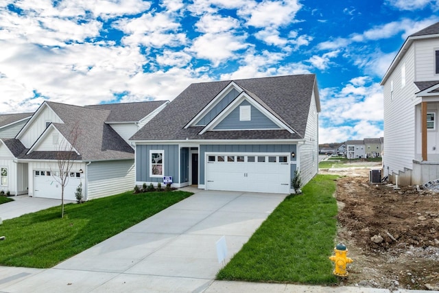 view of front of house featuring concrete driveway, central AC unit, board and batten siding, and a front lawn