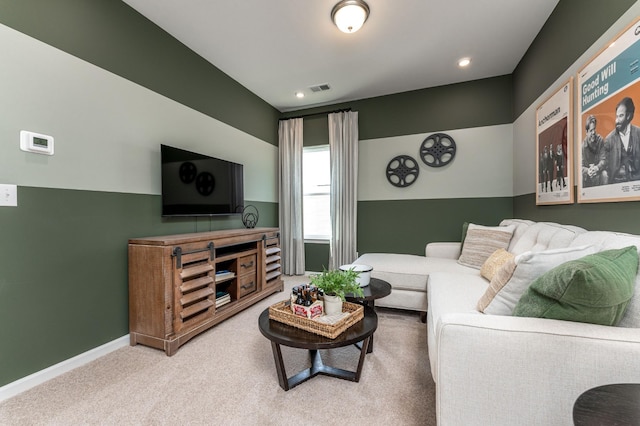 carpeted living room featuring visible vents and baseboards