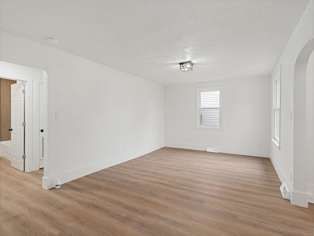 empty room with light hardwood / wood-style flooring