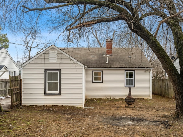 rear view of house featuring an outdoor fire pit