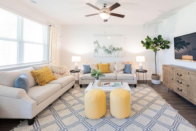 living room featuring ceiling fan and dark wood-type flooring