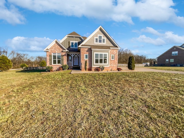 craftsman-style home featuring a front lawn