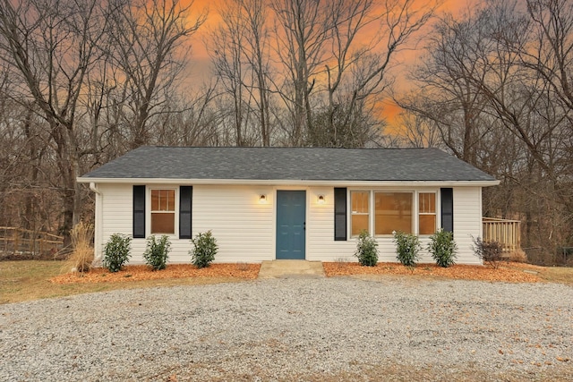 single story home with roof with shingles