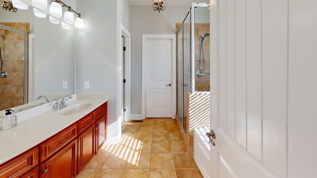 bathroom with tile patterned floors, vanity, and an enclosed shower