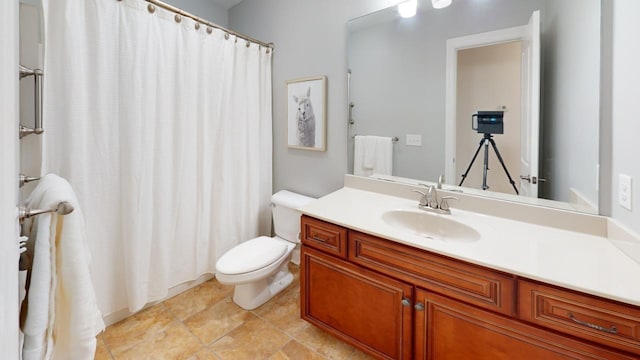 bathroom with vanity, tile patterned flooring, and toilet