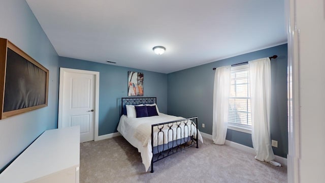 bedroom with light colored carpet