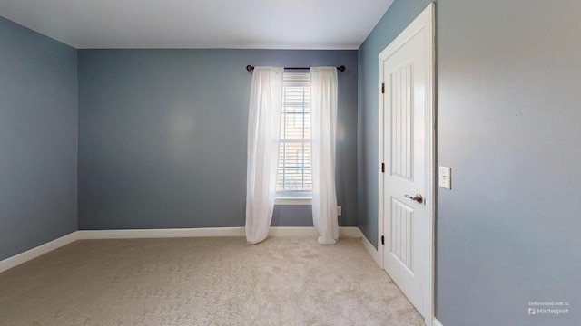 unfurnished room with light colored carpet