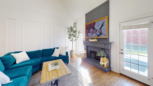 living room with high vaulted ceiling and wood-type flooring