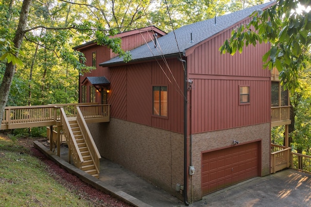 view of side of home with a deck and a garage