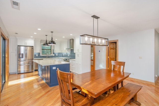 dining room with sink and light hardwood / wood-style flooring