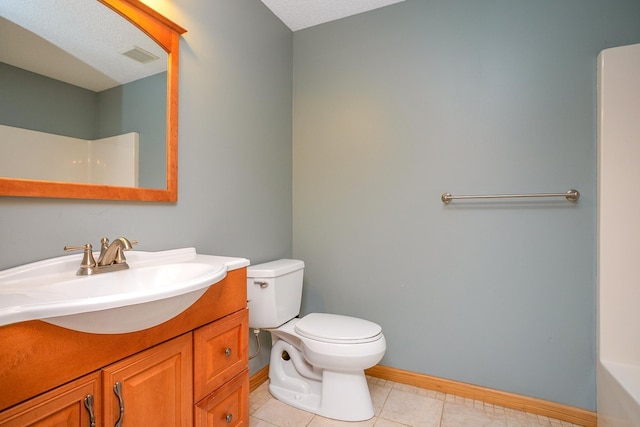 bathroom featuring vanity, toilet, and tile patterned floors