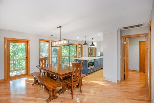 dining area featuring a notable chandelier and light hardwood / wood-style floors