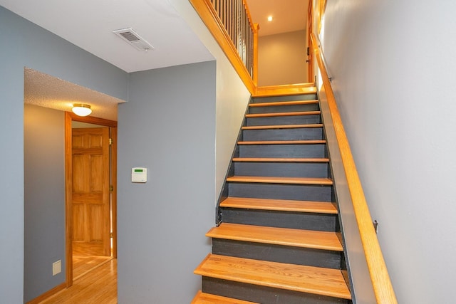 stairway featuring wood-type flooring