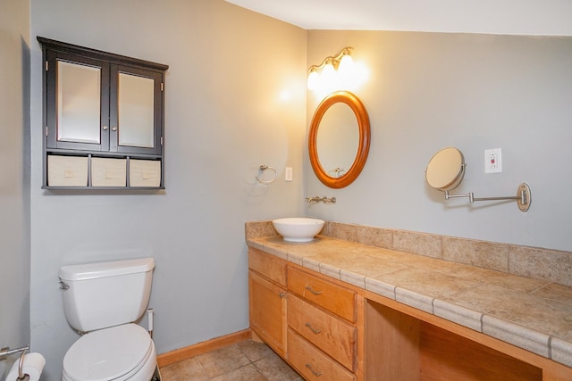 bathroom featuring toilet, tile patterned flooring, and vanity