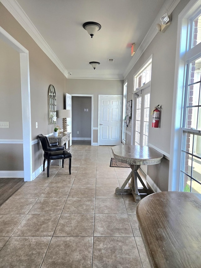 interior space featuring tile patterned flooring, visible vents, baseboards, french doors, and crown molding