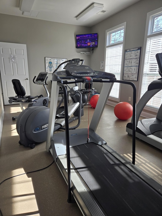 exercise room featuring visible vents and a wealth of natural light