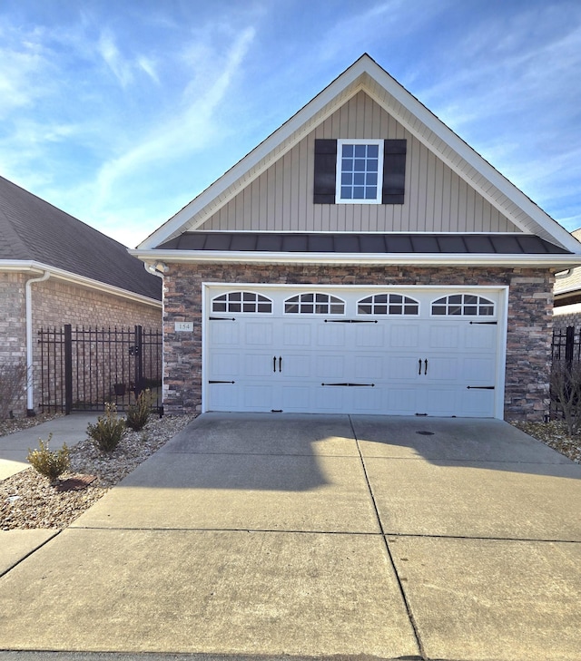 garage with fence and driveway