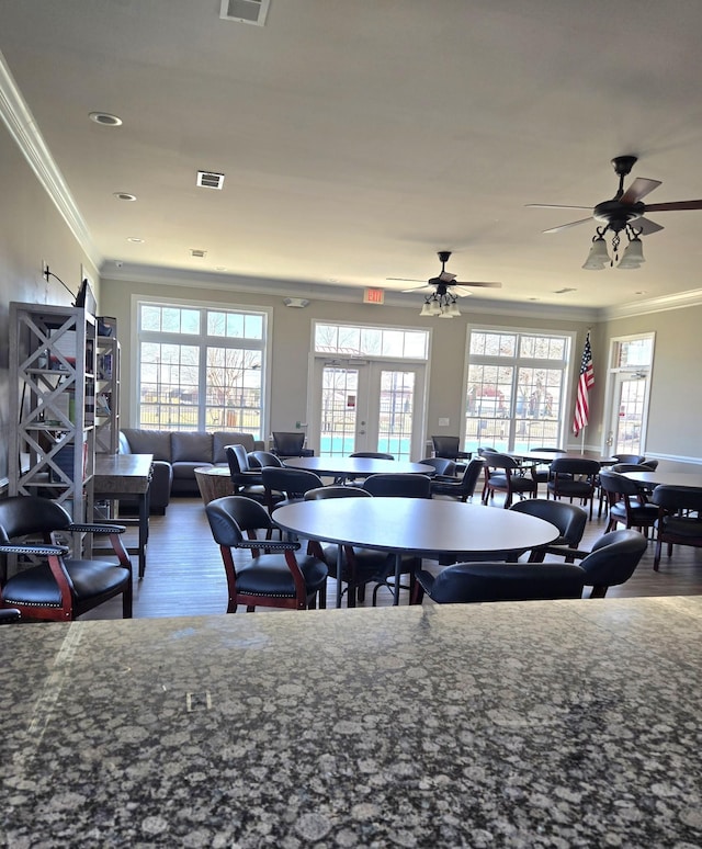 dining area featuring ornamental molding, french doors, visible vents, and wood finished floors