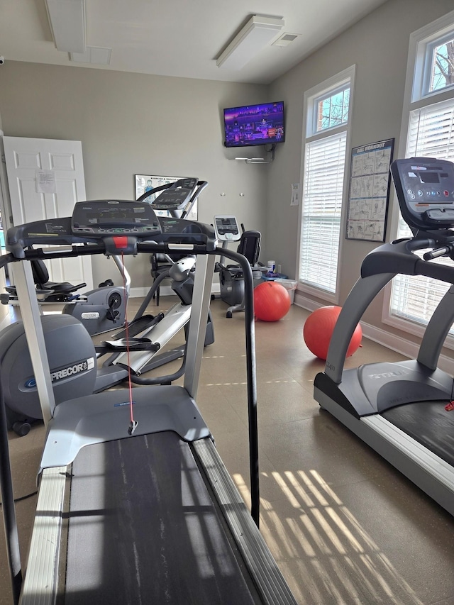 exercise room featuring visible vents and baseboards