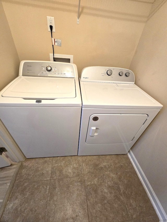 laundry room with laundry area, baseboards, and separate washer and dryer