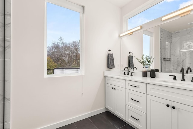 bathroom with tile patterned floors, a shower with door, and vanity