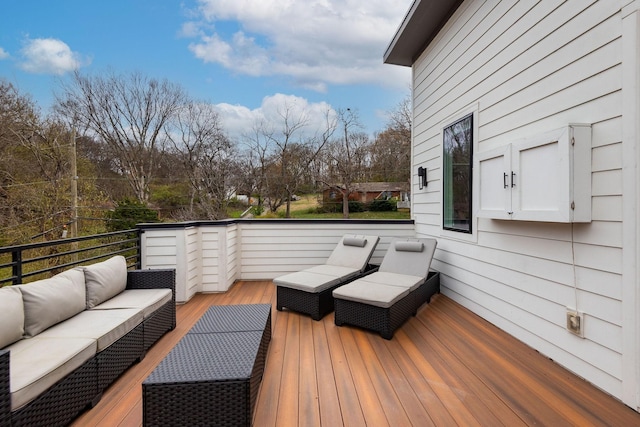 wooden deck with an outdoor living space