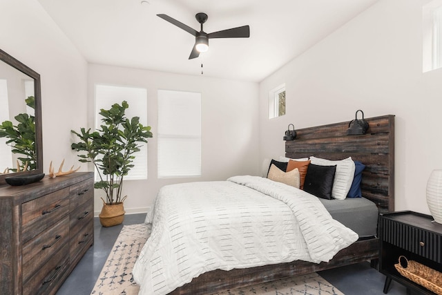 bedroom with ceiling fan and concrete floors