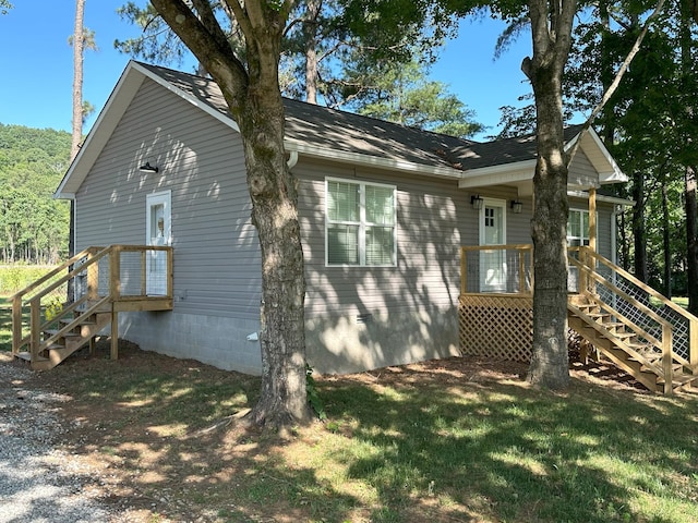 view of side of home with a lawn