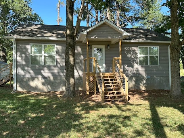 view of front facade featuring a front lawn and stairway