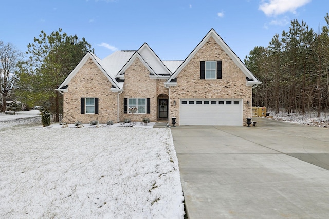 traditional-style house with an attached garage, concrete driveway, and brick siding