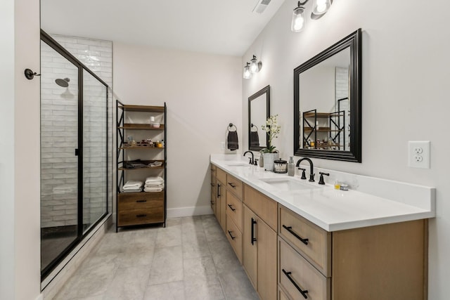 full bath featuring a stall shower, visible vents, a sink, and double vanity