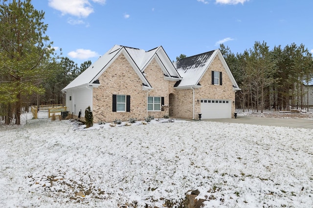 traditional-style home featuring a garage, brick siding, and driveway