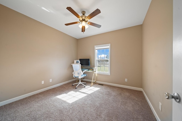 unfurnished office with ceiling fan and carpet flooring