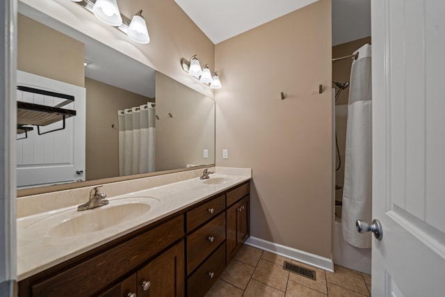 bathroom featuring tile patterned flooring, shower / tub combo with curtain, and vanity