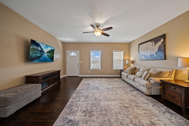 living room with ceiling fan and dark wood-type flooring