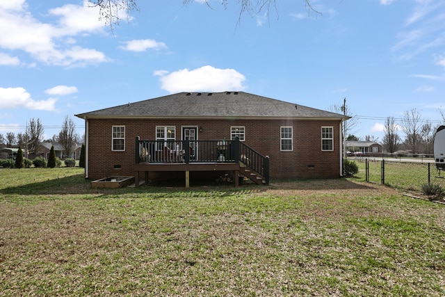 rear view of house with a lawn and a deck