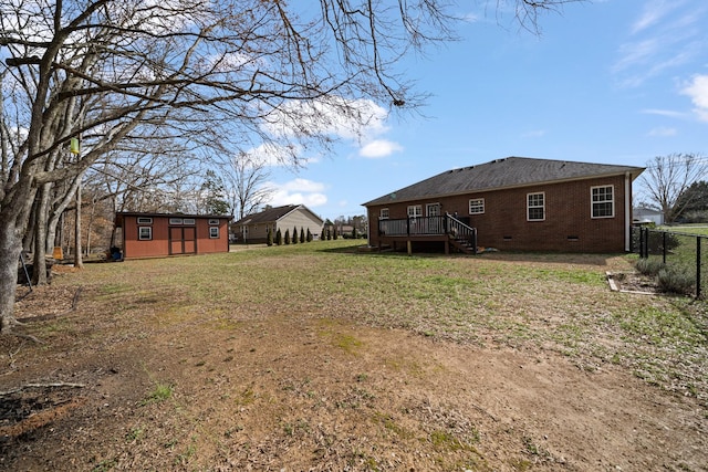 view of yard featuring an outbuilding and a wooden deck