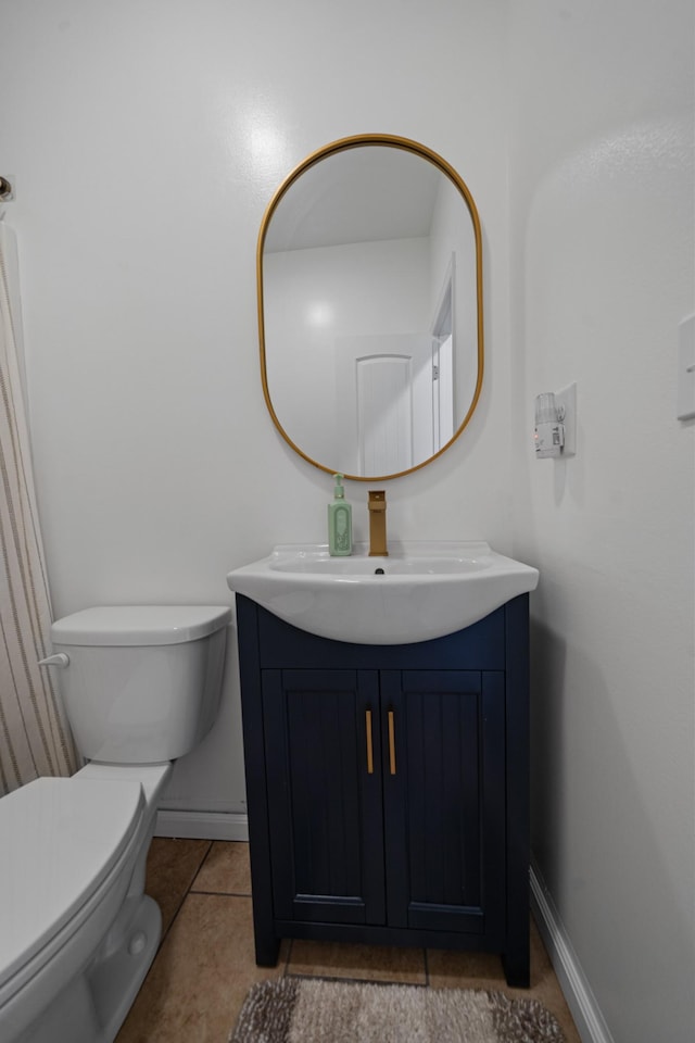 bathroom featuring tile patterned floors, toilet, and vanity