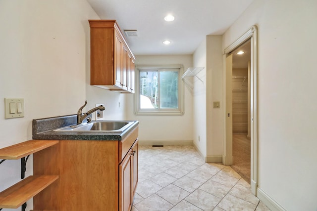 kitchen with light tile patterned flooring and sink