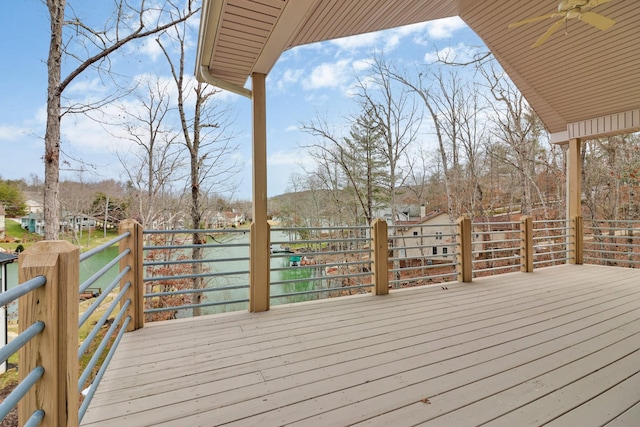 wooden deck with a water view and ceiling fan