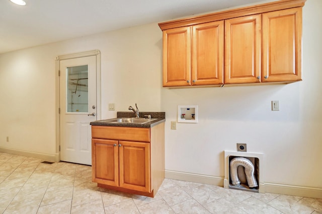 laundry area with hookup for a washing machine, hookup for an electric dryer, light tile patterned floors, sink, and cabinets