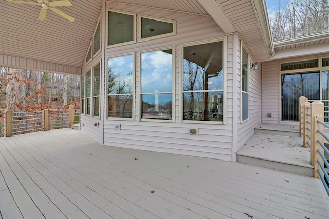 wooden terrace with ceiling fan and a sunroom