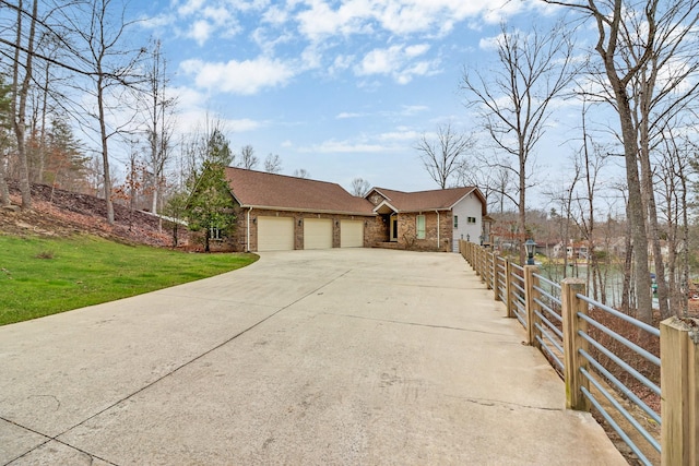 ranch-style house with a garage and a front yard