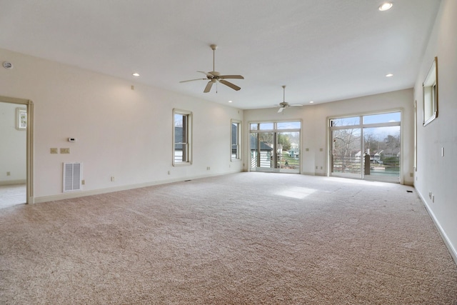 unfurnished living room with light colored carpet