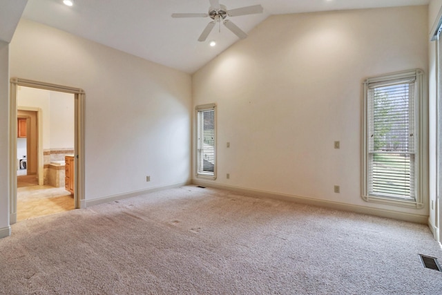 carpeted empty room with high vaulted ceiling and ceiling fan